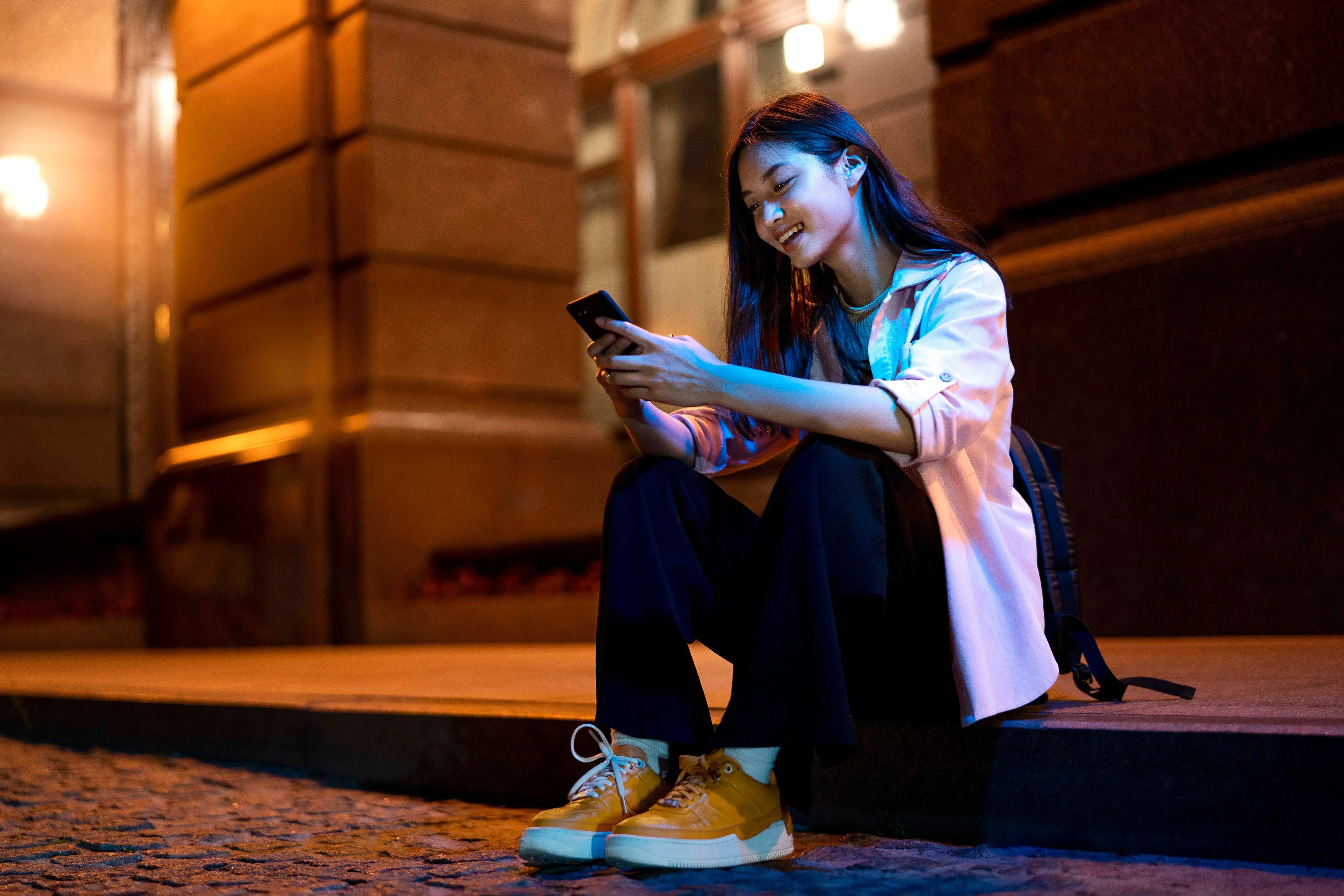 portrait-woman-using-smartphone-night-city-lights